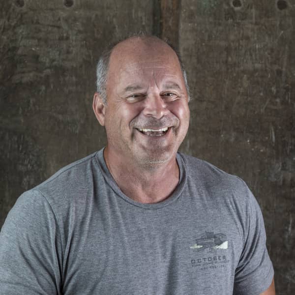 Jim Brophy, Partner/Architectural & Design Team Management, wearing a gray T-shirt with the October 5 logo and smiling at the camera.