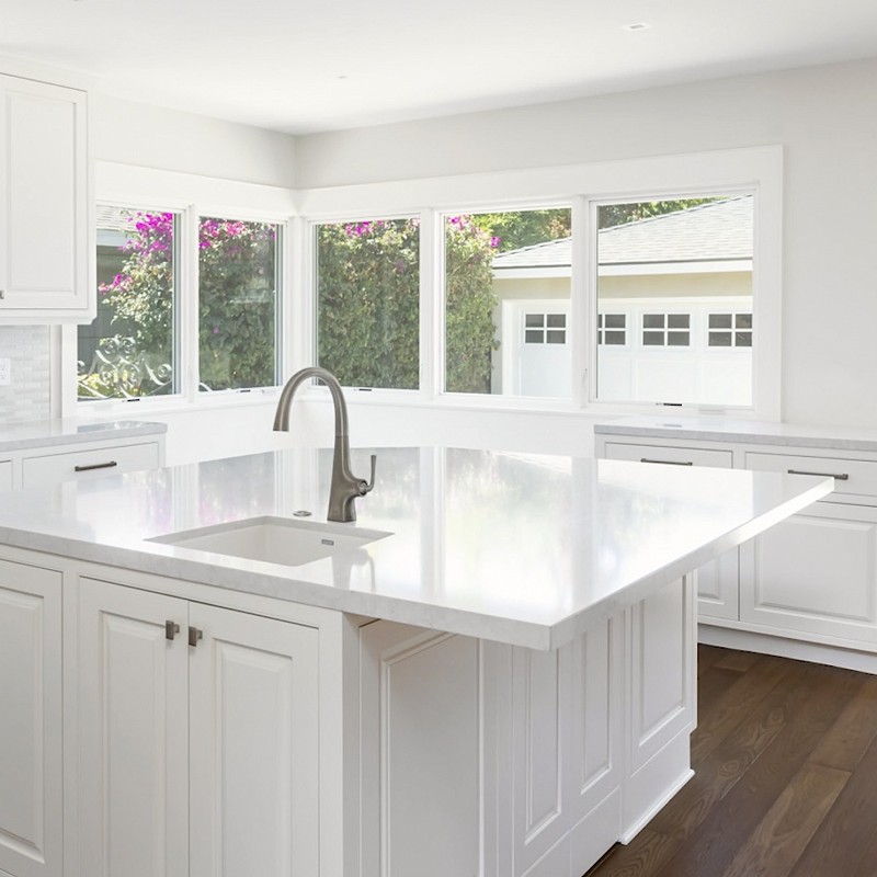 New kitchen with white counters and cabinetry